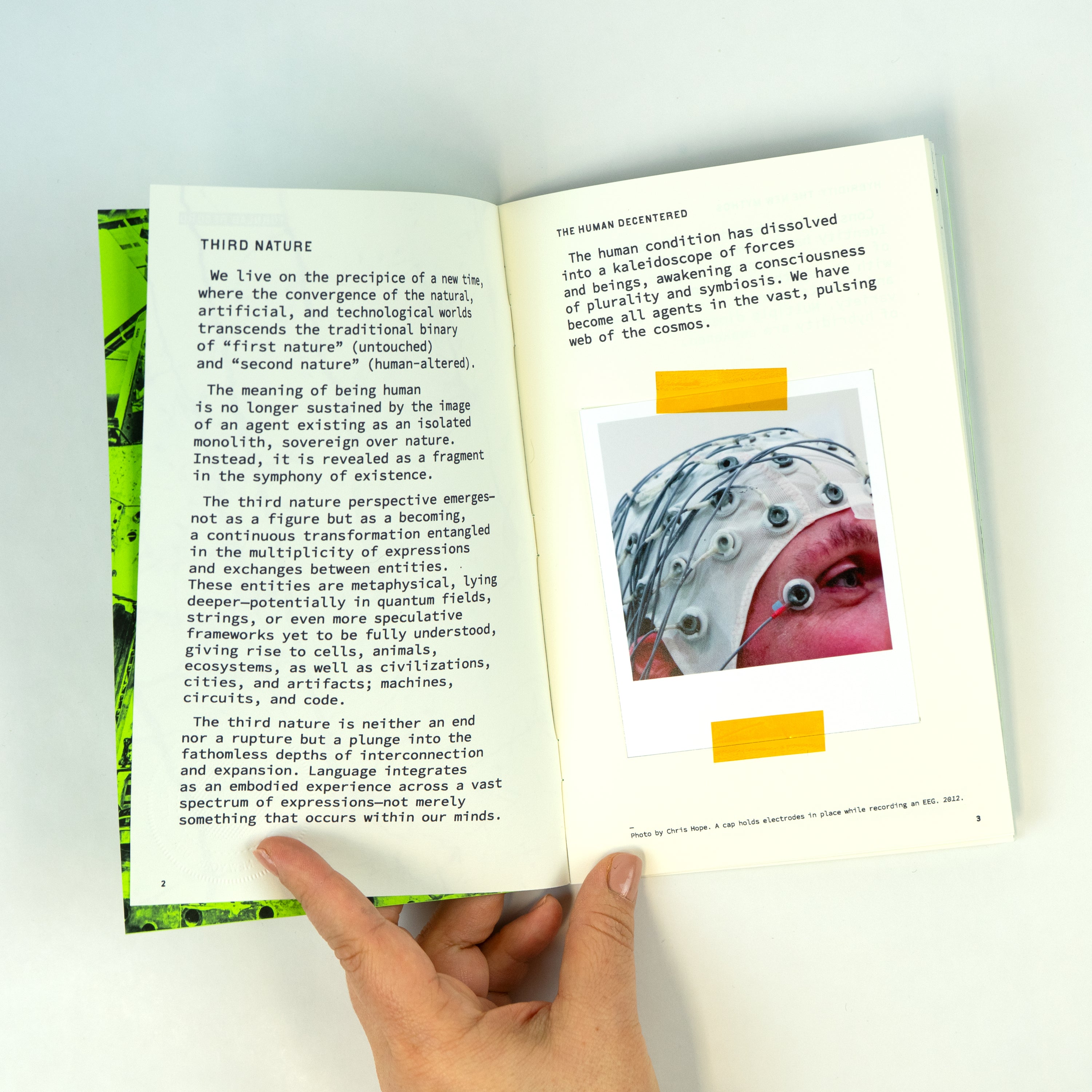 An open zine with text on both pages and a polaroid taped to the page.