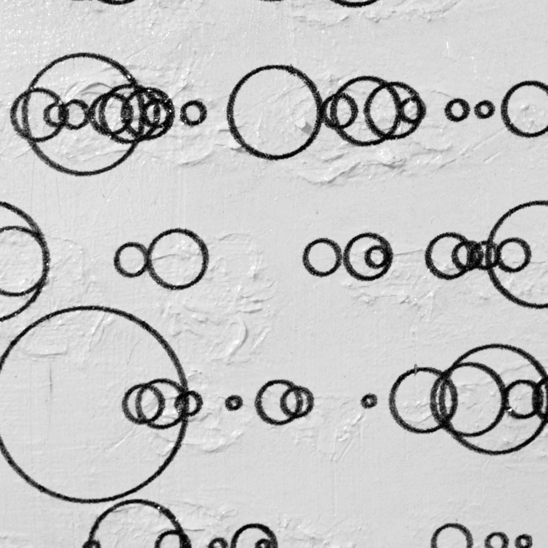 Pattern of black circles on a textured gray background