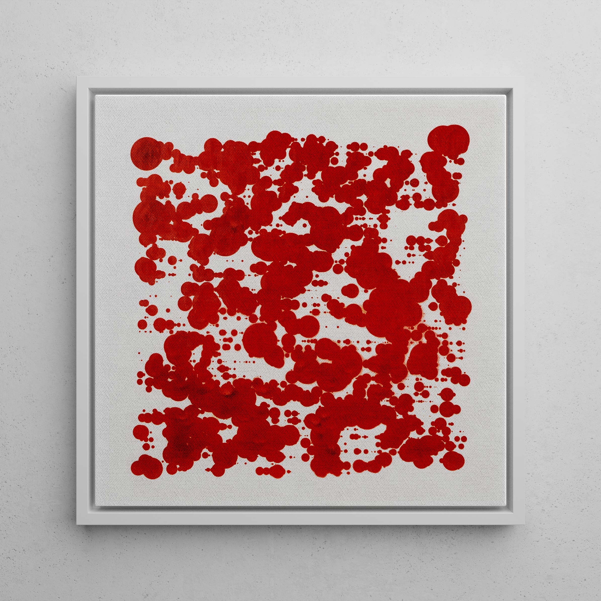Framed abstract art with red pattern on a gray wall