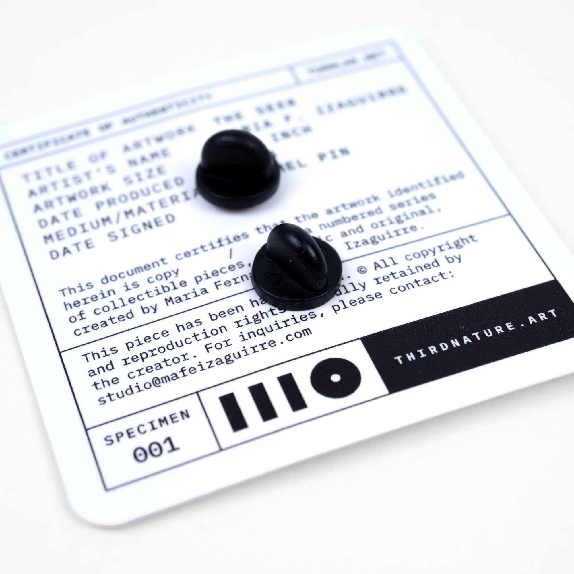 Black rubber locks for an enamel pin on a certificate of authenticity with 'Third Nature Art' branding.